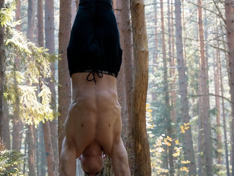 Person performing a controlled bodyweight exercise in a minimalist setting.